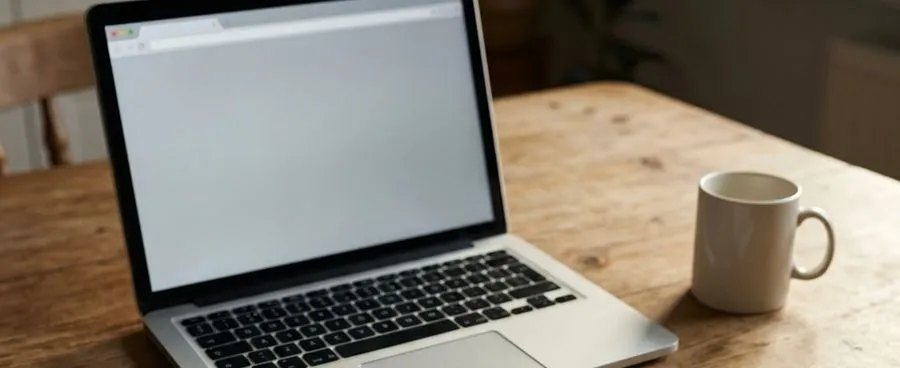 A hand-drawn flowchart on an index card beside an open laptop on a kitchen table.