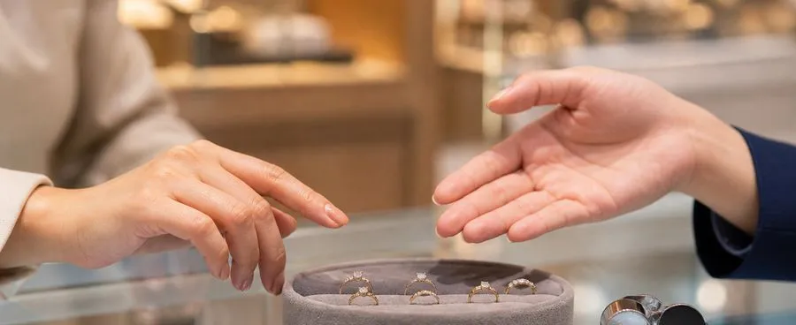 A ring dish and jeweler's loupe on a counter during an engagement ring purchase.